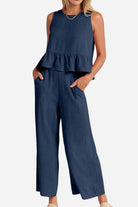 Women's navy linen-like feel set with sleeveless ruffled top and wide-leg pants, lightweight and breathable for travel.