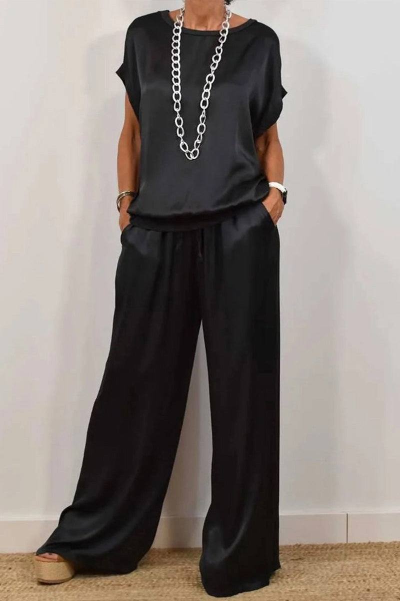 Silken Escape Satin Two-Piece Set black satin relaxed fit top and wide-leg pants with pockets and stretch waistband.
