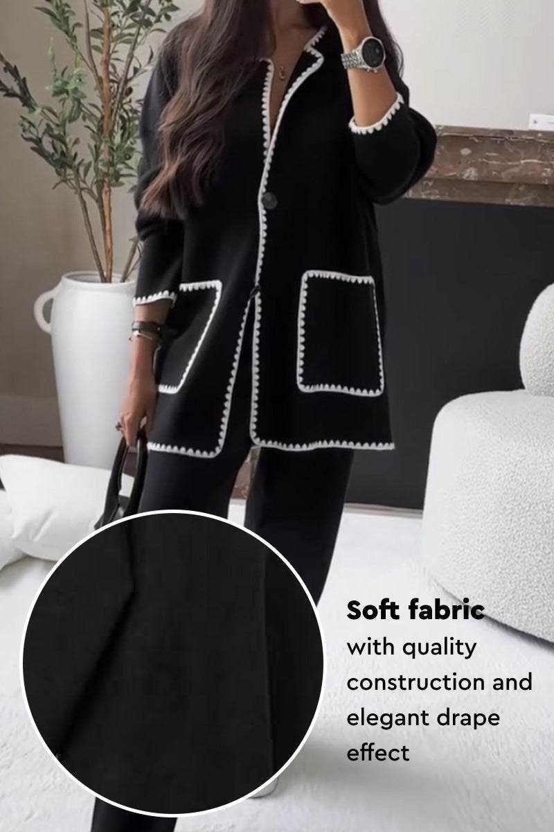Black contrast-trim knit cardigan with pockets, soft fabric, and elegant drape effect.
