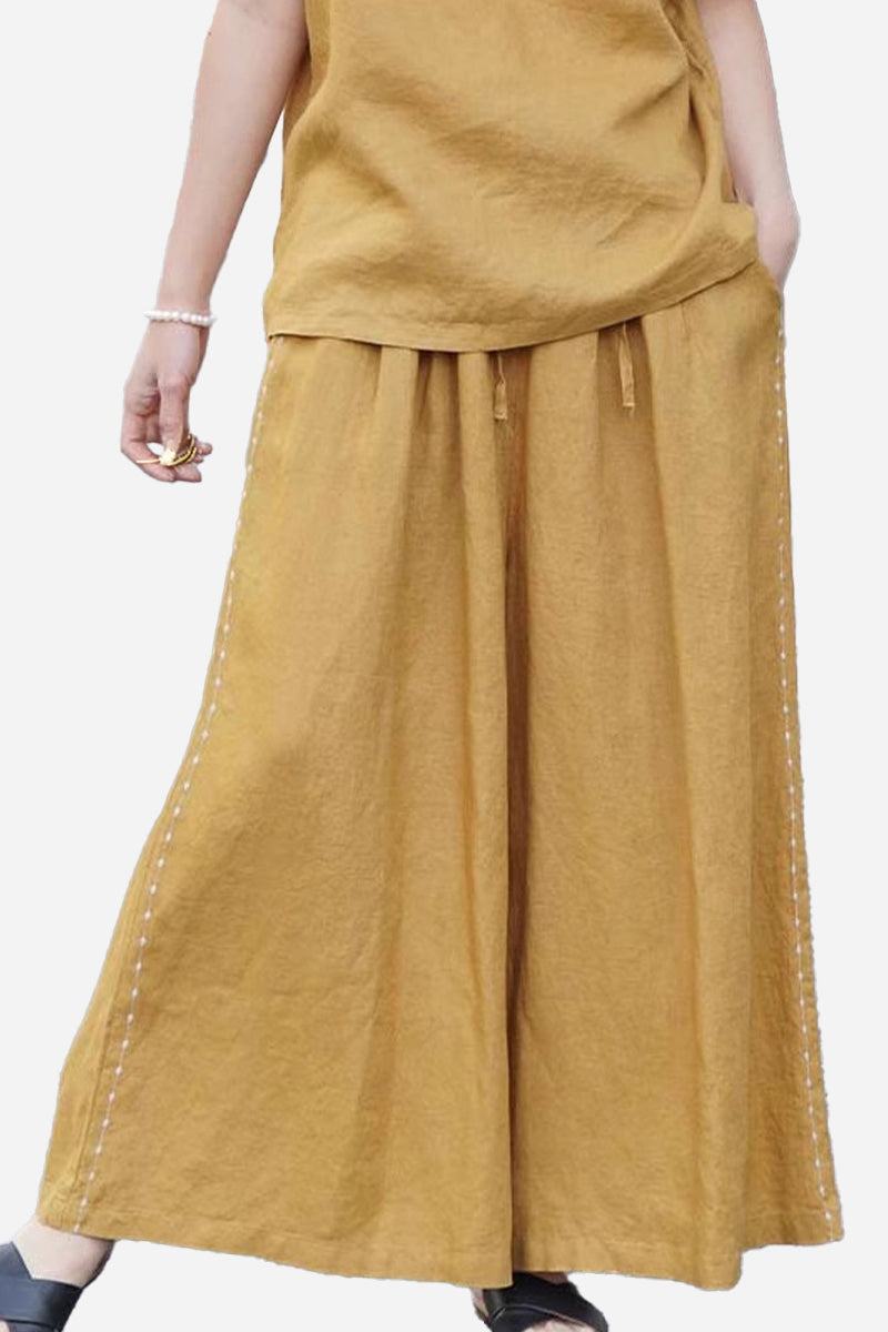 Wide-leg 100% linen pants in mustard yellow with elastic waist and relaxed fit.