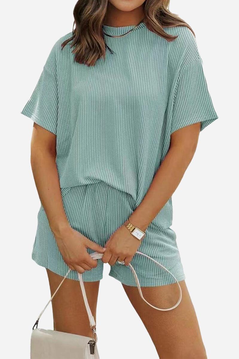 Woman wearing a comfortable ribbed short-sleeve top and matching shorts set for slow mornings in soft green polyester fabric