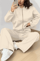 The Voyager Zip Set cream zip-front sweatshirt and wide-leg joggers travel outfit with pockets and white sneakers