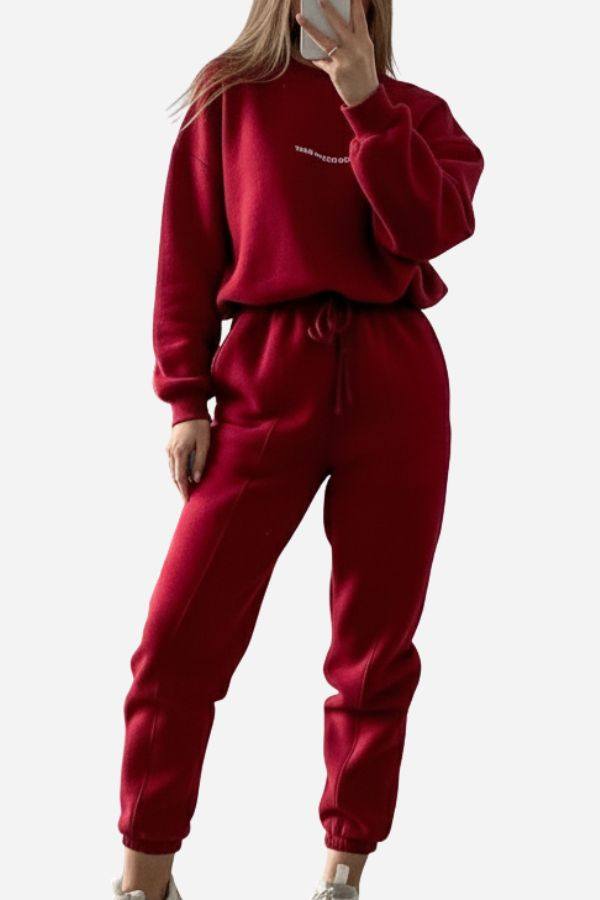 woman wearing red Storm Sweater Mock Neck athleisure set with relaxed fit and adjustable waist