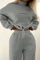 woman wearing gray Storm Sweater Mock Neck athleisure set with relaxed fit and adjustable waist