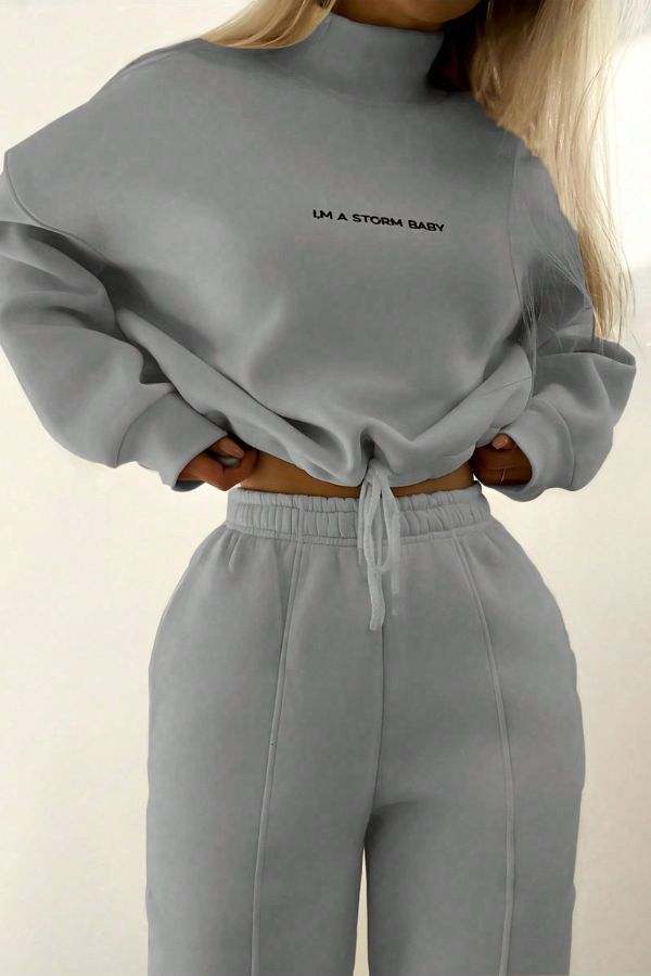 woman wearing gray Storm Sweater Mock Neck athleisure set with relaxed fit and adjustable waist