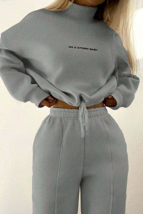 woman wearing gray Storm Sweater Mock Neck athleisure set with relaxed fit and adjustable waist