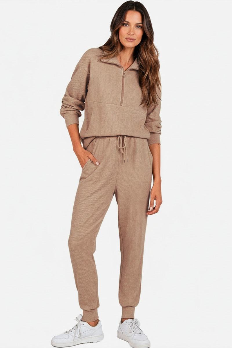 Unisex half-zip pullover and sweatpants set in beige with stand collar, casual fit, and lightweight polyester blend.