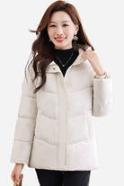 Woman wearing beige Everyday Warmth mid-length hooded coat with 5-layer thermal insulation and wind-resistant shell