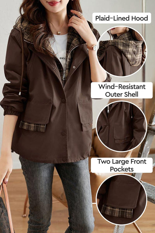 Woman wearing brown City Explorer Plaid Windbreaker with plaid-lined hood, wind-resistant shell, and two large front pockets.
