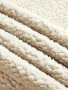 Faux suede sherpa coat with contrast trim, mid-thigh length, and side pockets for lightweight warmth and casual style