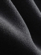Close-up of soft black lyocell-blend fabric texture from hooded set