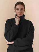Woman wearing a black Warm & Easy Two-Piece Set pullover hoodie with button-collar and relaxed fit.