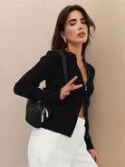 woman wearing slim zip-up knit cardigan jacket with vertical ribbing and high neckline