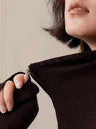 women wearing slim fit zip-up knit cardigan with vertical ribbing and high neckline