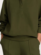 Wrinkle-free polo set with quarter-button top and high-waisted pants in breathable fabric