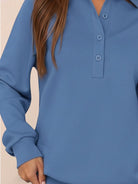 Wrinkle-free polo set with quarter-button top and high-waisted pants in breathable, structured fabric.