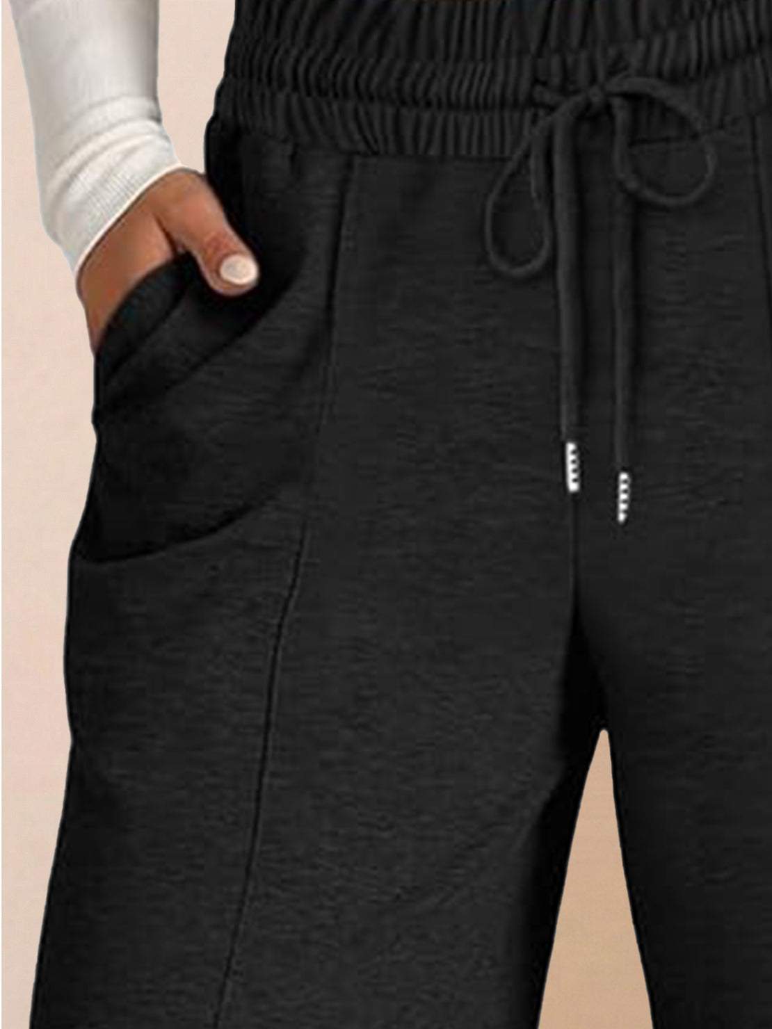 Soft knit wide-leg pants with breathable fabric, elastic drawstring waist, and side pockets for a relaxed everyday fit