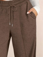 Soft knit wide-leg pants in breathable fabric with elastic drawstring waist and side pockets.