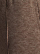 Soft knit wide-leg pants with breathable fabric, elastic drawstring waist, and functional side pockets for a relaxed everyday fit