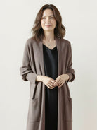 Long open-front cardigan made of 100% Australian Merino Wool with patch pockets and ribbed cuffs, perfect for layering in cool weather