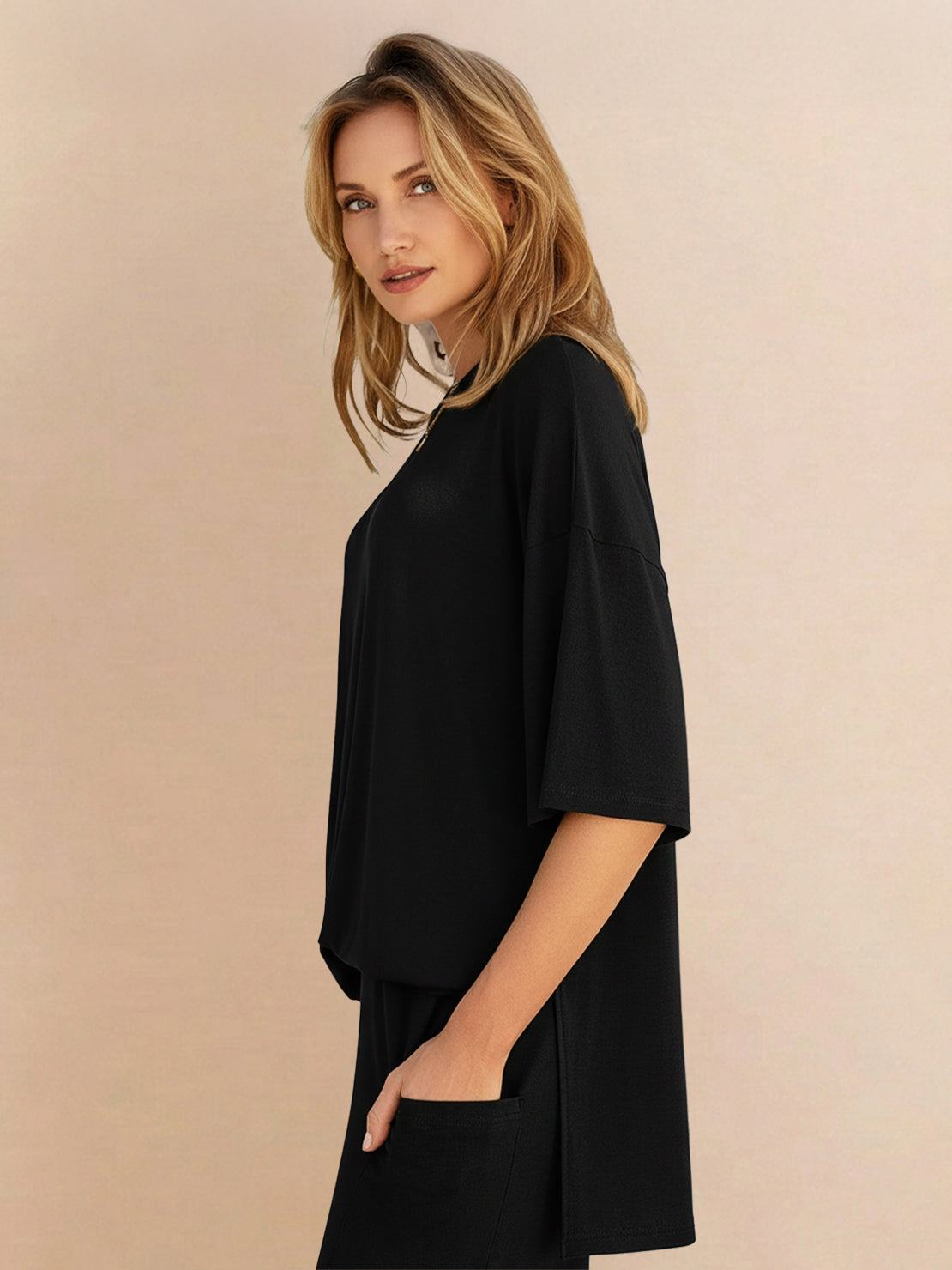 Woman wearing oversized long-line pullover and wide-leg pants loungewear set