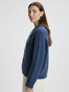 Lightweight wool-blend button-front cardigan with wide collar and five-button closure for layering and warmth