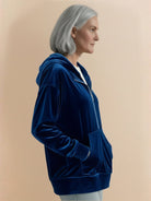 Ultra-soft velvet half-zip hoodie with plush texture and kangaroo pocket