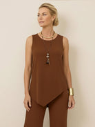 Woman wearing open-front three-piece co-ord with longline cardigan, tank top, and wide-leg trousers