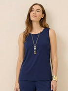 Woman wearing open-front three-piece co-ord with longline cardigan, tank top, and wide-leg trousers in lightweight knit fabric