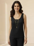 Woman wearing open-front three-piece co-ord with longline cardigan, tank top, and wide-leg trousers