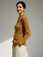 Asymmetric wrap ribbed knit top with diagonal button closure and flared cuffs