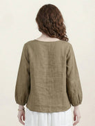 100% cotton-linen embroidered blouse with relaxed boxy fit, 3/4 balloon sleeves, and tonal floral embroidery on shoulder