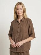 woman wearing 100% cotton artisan two-piece set with oversized button-front shirt and wide-leg pants