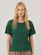 Floral jacquard pleated top with 3D floral texture, flutter sleeves, round neckline, and relaxed A-line silhouette