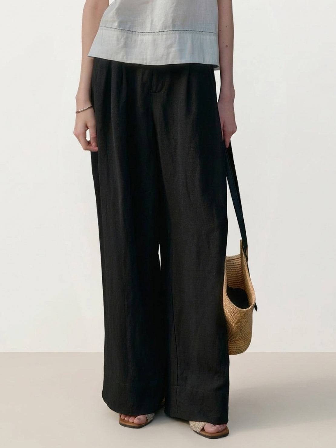 White Tencel-linen pleated wide-leg pants with structured waist and floor-skimming silhouette