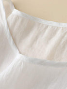 100% cotton-linen hand-embroidered shirt with 3/4 flare sleeves and asymmetric hem