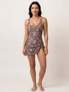 Ruched wrap one-piece swimdress with adjustable straps and tie-front skirt in matte fabric