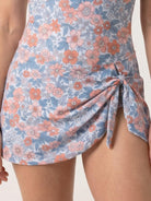 Ruched wrap one-piece swimdress with adjustable straps and tie-front wrap skirt on model