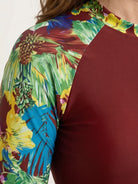 Two-piece tropical print rash guard set with long sleeves and matching swim shorts