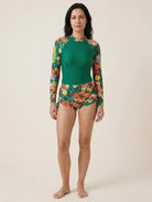Two-piece tropical print rash guard set with long sleeves and boy-cut shorts for sun protection and active water use