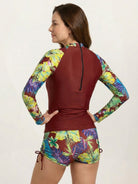 Two-piece tropical print rash guard set with long-sleeve top and boy-cut shorts