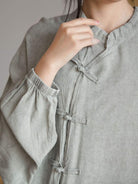 Oversized linen-cotton tang knot blouse with batwing sleeves and asymmetric hem