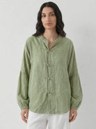 Oversized linen-cotton blouse with batwing sleeves and frog button closures