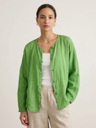 Oversized 100% linen blouse with frog-button closure and curved hem in lightweight fabric