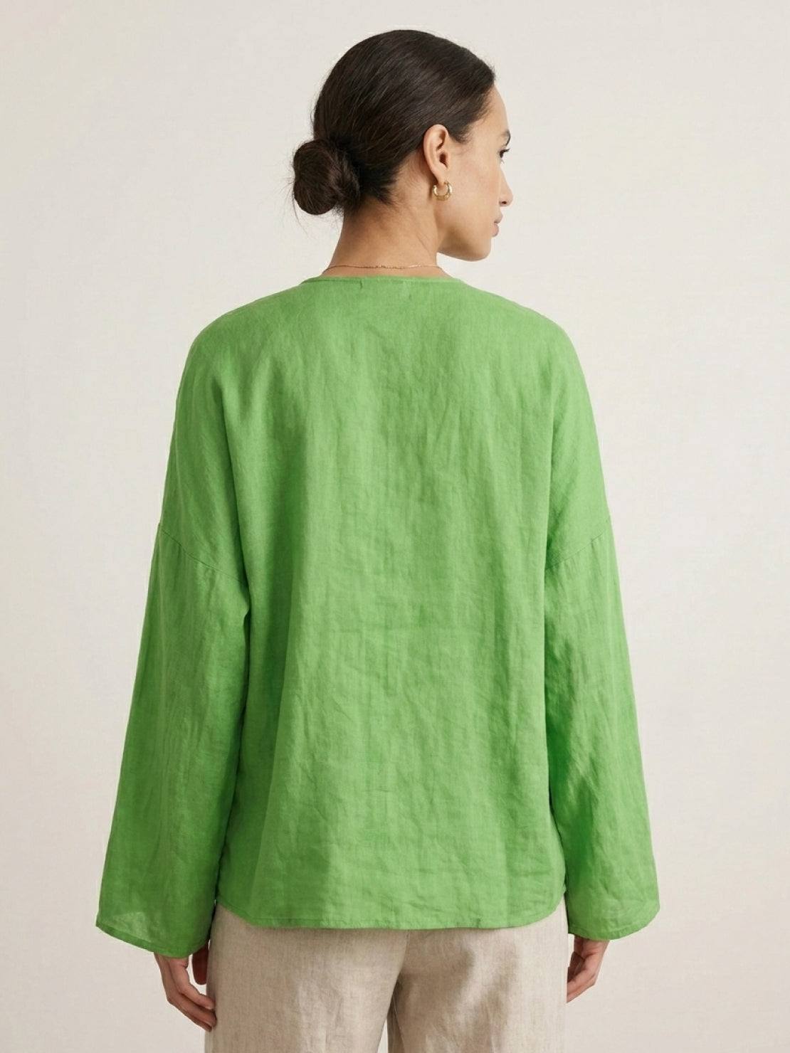 Oversized 100% linen blouse with traditional frog-button closure and curved hem in lightweight semi-sheer fabric