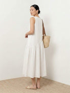 Lightweight cotton-linen summer midi dress with loose fit and tiered skirt in natural fabric texture