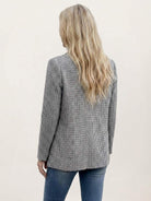 Classic houndstooth commuter blazer with structured shoulders and relaxed fit in black and white pattern