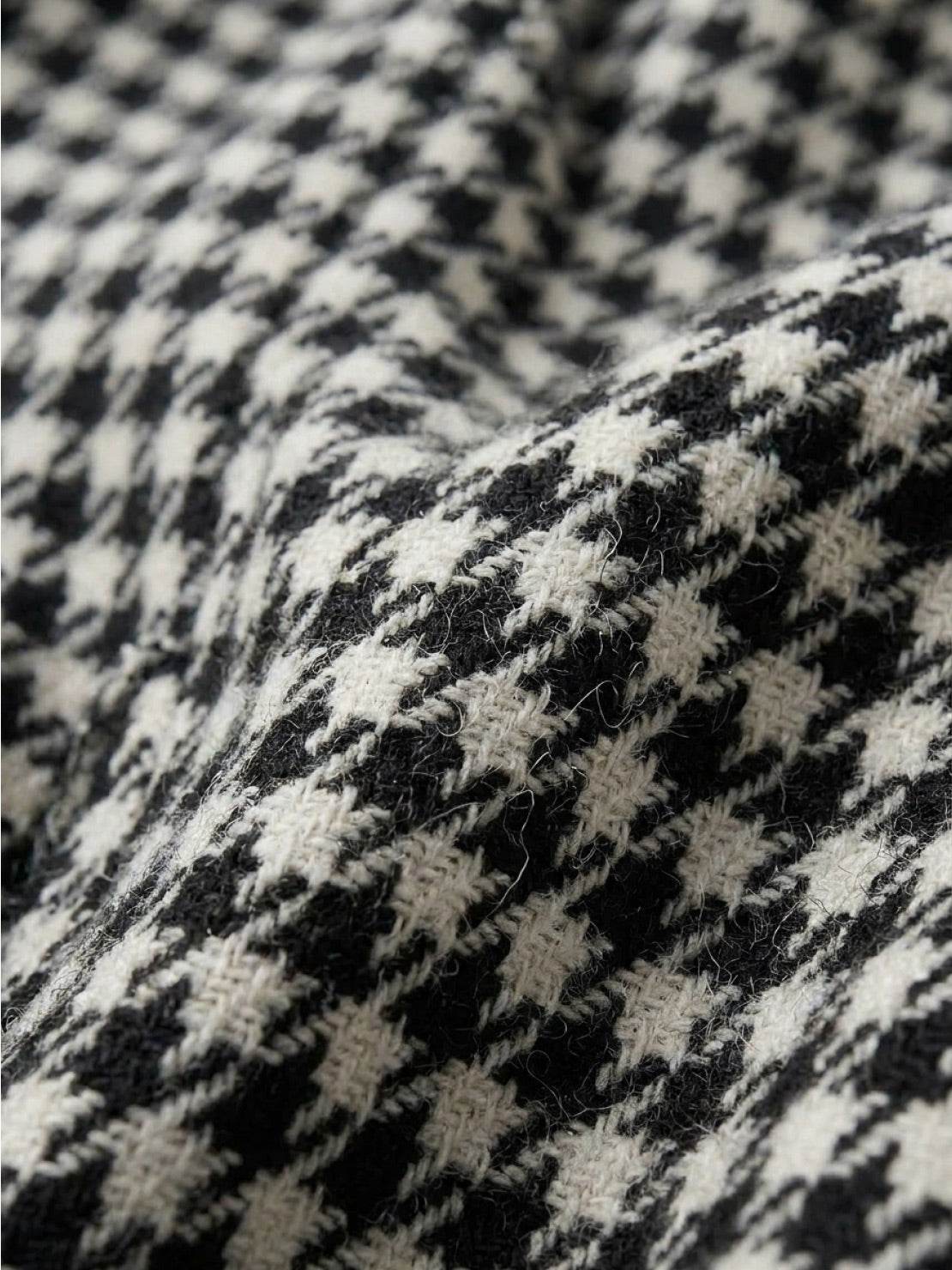 Black and white houndstooth commuter blazer with structured shoulders and relaxed fit