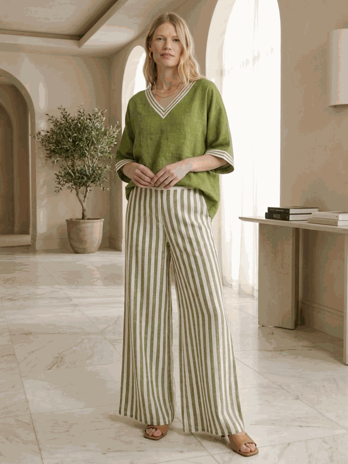 Woman wearing striped wide-leg co-ord set with oversized top and palazzo pants with elastic waist and side pockets