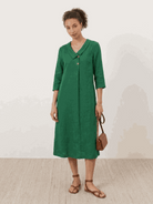 Woman wearing a navy linen-look midi dress with 3/4 sleeves and side pockets